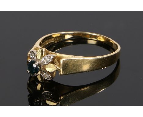 18 carat gold sapphire and diamond set ring, with a central sapphire and diamonds to flower head petals, ring size R