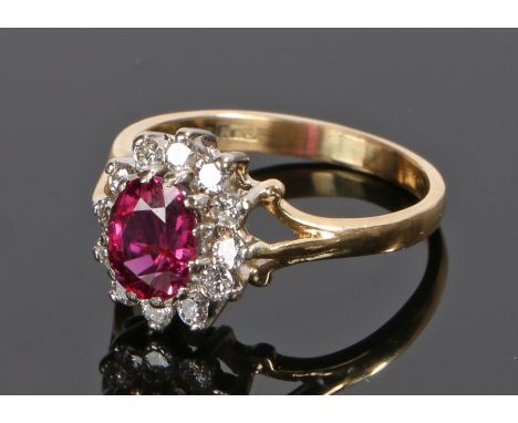 18 carat gold ruby and diamond set ring, the central East African ruby at 1.44 carats, cushion cut with a diamond surround, t