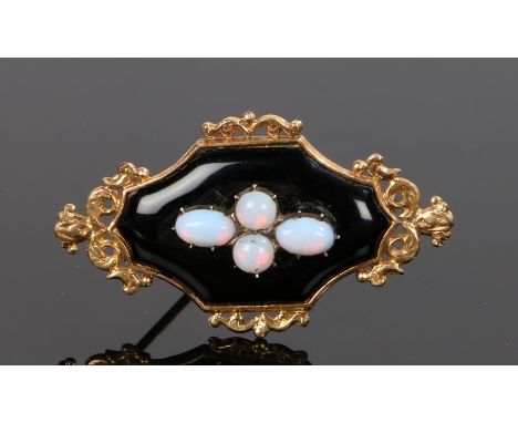 Opal brooch, with four opals to the centre onto the black ground and yellow metal mount, 45mm diameter 