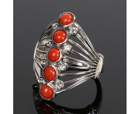 Silver and coral ring, with a row of five round coral beads to the wide hide, ring size Q