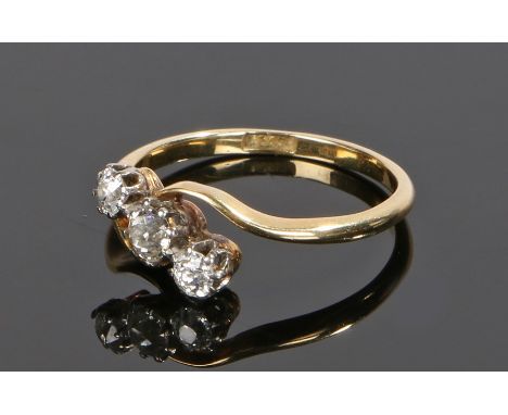 18 carat gold diamond set ring, with three round cut diamonds to the cross over head, ring size N