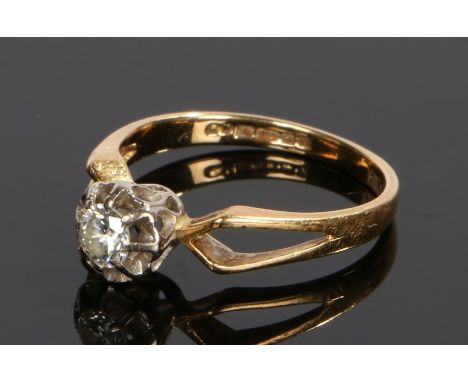 18 carat gold diamond set ring, with a round cut diamond above a flower head design and angled shoulders, ring size N