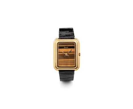 Piaget 14101 caliber Beta 21, 1970s Rectangular stepped case in 18k gold. Tiger eye stone dial. Quartz movement. Leather stra