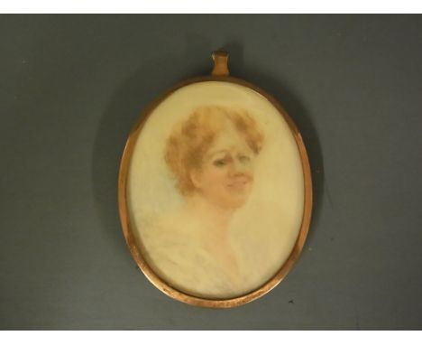 A miniature portrait of a Lady in a silver gilt surround with hanging loop to top Condition report: Miniature slightly faded 