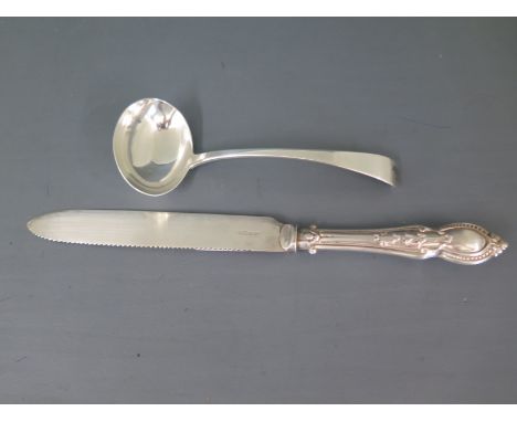 A silver ladle maker DF London 1929/30 - approx weight 2 troy oz and a plated knife both with usage marks but clean