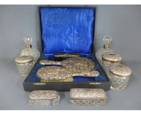 A silver hallmarked and cut glass dressing set consisting of seven pieces, two silver rimmed bottles, two pin trays etc and a