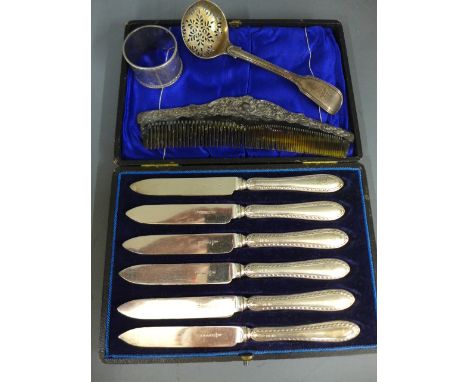 A boxed set of six silver handled knives, a silver napkin ring, a silver sifter and a silver top comb - approx weight of weig