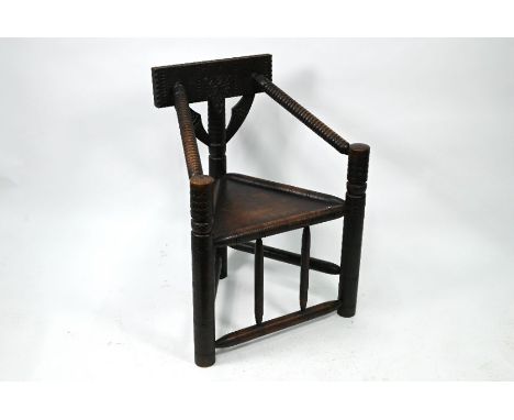 A late Victorian oak turners chair, with carved decoration and panel seat (height to seat 45 cm)No evidence of wood worm (old