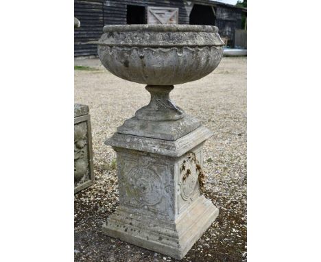 A Regency style weathered reconstituted stone garden urn planter standing on a square pedestal base, 98 cm high o/a&nbsp;&nbs