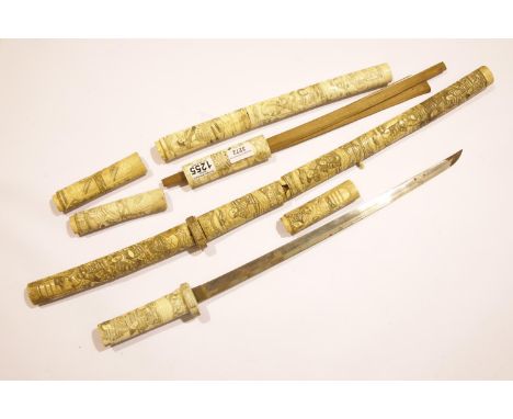 Heavily carved pair of late 19th century Japanese ivory Wakizashi swords. Both are complete but scabbard and grip sections ha