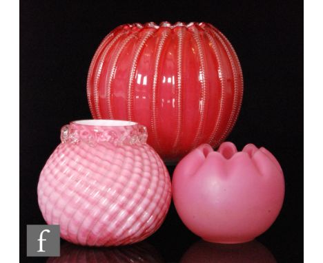 A group of late 19th to early 20th Century glass posy bowls comprising a satin pink example with crimped rim and enamelled de