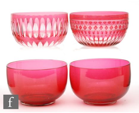 A group of finger bowls, two cased in ruby and flash cut and two of plain form in ruby. (4)
