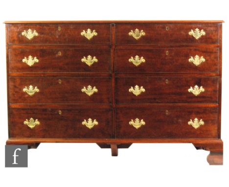 A George III crossbanded mahogany North Counties chest fitted with eight cock beaded drawers, brass fret drop handles on brac