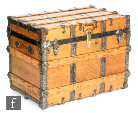 A late 19th Century metal bound steamer trunk with leather loop side handles, height 65cm, width 87cm and depth 54cm, complet
