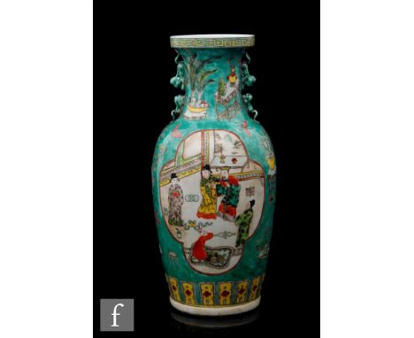 A Chinese famille verte vase of baluster form, rising to a wide dished mouth rim, the green glaze with fan shaped panels fill