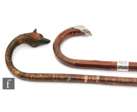 A Victorian walking stick with silver ferule and horse's hoof tip and a similar carved walking stick with fox's head handle (