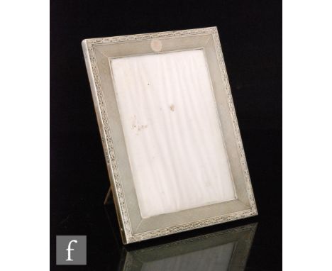 A hallmarked silver rectangular easel photograph frame with engine turned decoration within cross detailed borders, height 18