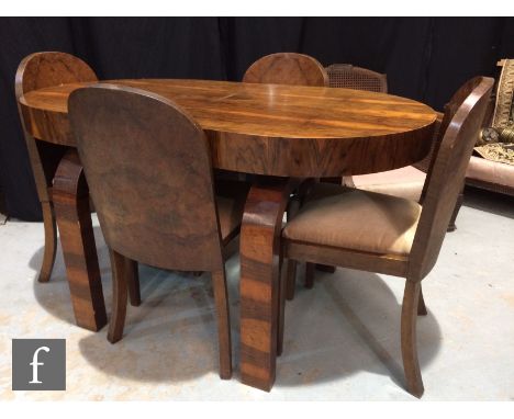 A 1930s walnut veneered dining table of oval form, raised to strut type legs, together with four conforming solid panel back 