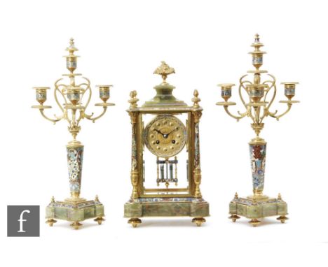 A late 19th Century French three piece champleve enamel and green onyx clock garniture, the clock dial signed 'A la Gerbe D'O