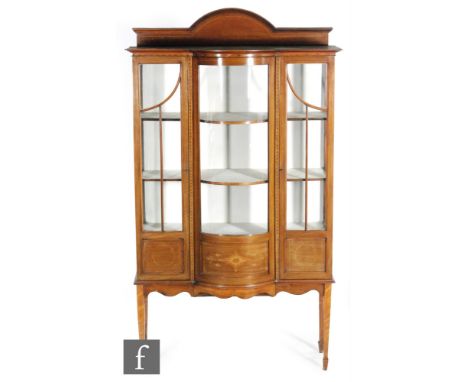 An early 20th Century marquetry and line inlaid bow-fronted cabinet, with upright gallery panel above two glazed doors and a 