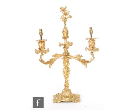 A late 19th to early 20th Century ormolu twin light candelabra, with a central foliate finial above acanthus scroll arms and 