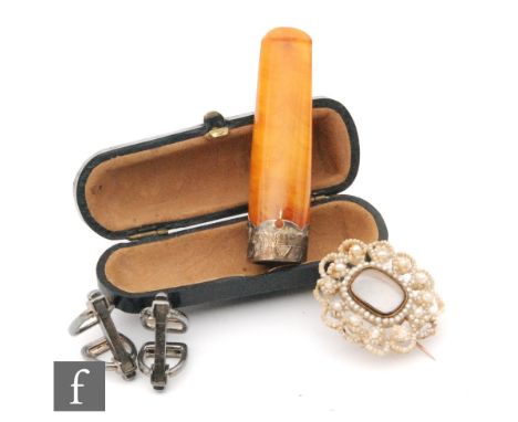 A Georgian seed pearl oval memorial brooch with central vacant glass panel, a pair of cufflinks modelled as horseshoes and an