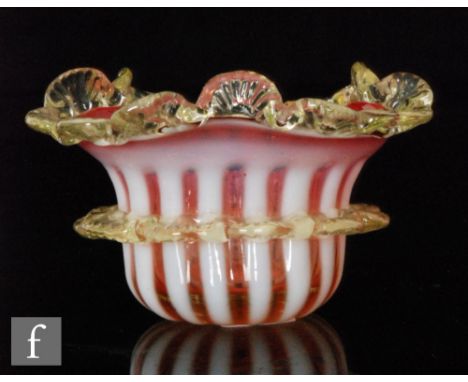 A 19th Century table salt with white opalescent stripes to a ruby shaded ground with applied citron frill and rim, diameter 8