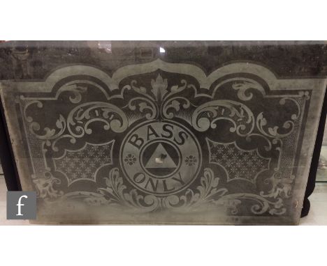 An early 20th Century acid etched glass pub window panel, the central cartouche lettered 'Bass Only', within a foliate scroll