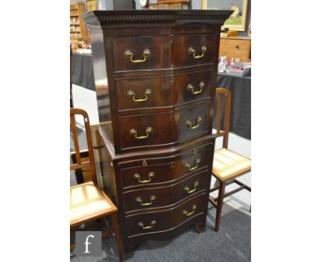 A reproduction serpentine fronted mahogany veneered chest on chest in the Georgian style, fitted with an arrangement of six d