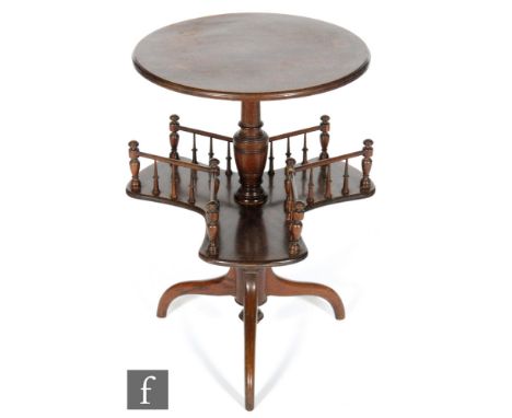 A late 19th to early 20th Century mahogany reading table of circular form, raised to a turned pedestal with a revolving tri-f