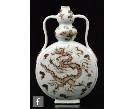 A Chinese porcelain moonflask, the flat circular body extending to a gourd shaped neck and flanked by twin handles, the white