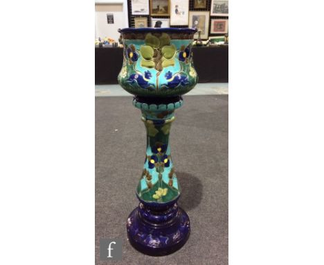 An early 20th Century Burmantofts jardiniere and pedestal, the urn form jardiniere resting aloft a column form plinth, incise