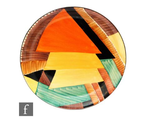 A 1930s Susie Cooper wall charger in a Geometric design over lapping triangles and panels in orange, yellow, green, tonal bro