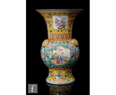 A Chinese famille rose yellow-ground vase of baluster form, rising to a large upper flared trumpet rim, applied with solid gi