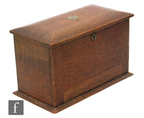 A Victorian oak stationery cabinet with fitted divisioned interior and a single glass inkwell above two internal drawers, wid