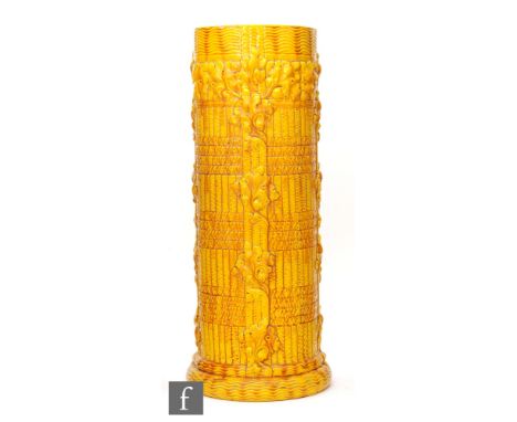 An early 20th Century Burmantofts stick stand, of cylindrical form, relief moulded to the exterior with stylised foliate and 