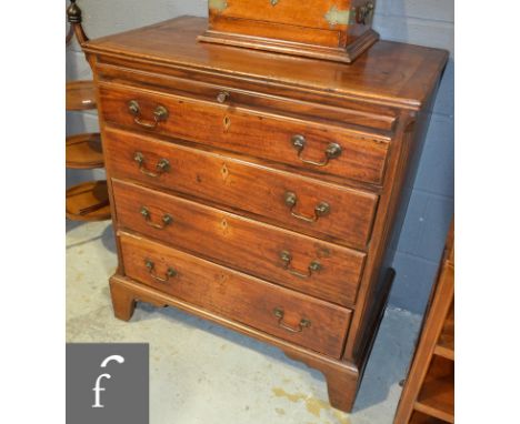 A George III mahogany bachelors chest of four long graduated drawers, beneath a brushing slide and flanked by reeded pilaster