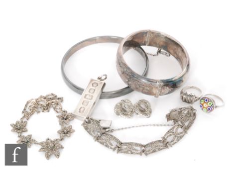 A small parcel lot of silver jewellery to include a marcasite panel bracelet and necklet, two bangles, two rings a pair of ea