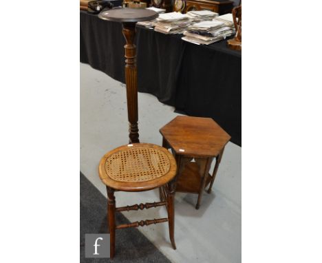 An early 20th Century occasional table of hexagonal form, with mirhab shaped arched sides over a stretcher shelf, together wi