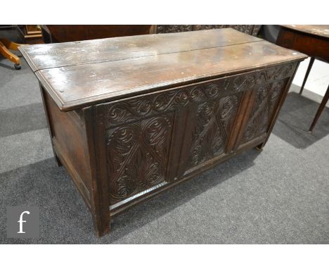 An 18th Century oak coffer, with a later acanthus carved triple fielded front panel over stile feet, height 63cm and width 13