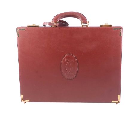 Le Must de Cartier, a burgundy leather briefcase, fold-down flap to interior, gold-plated stud feet, corner brackets and catc