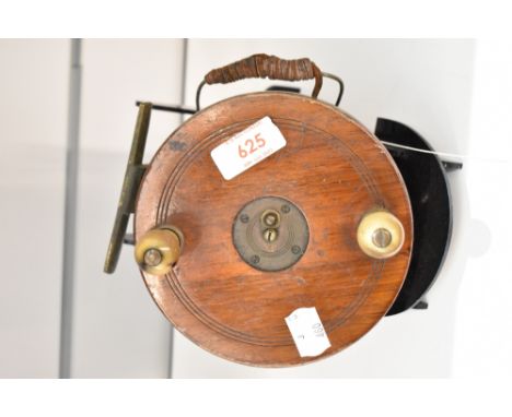 A Vintage wood and brass reel measuring 14cm diameter