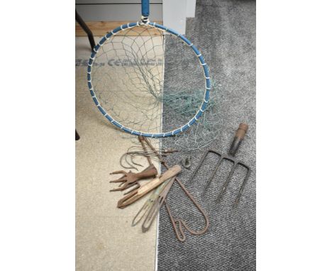 A Large landing net some net repairing tools and some vintage poaching equipment