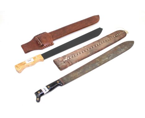 Two machete's, one a decorative (not sharpened) example in tooled leather scabbard 