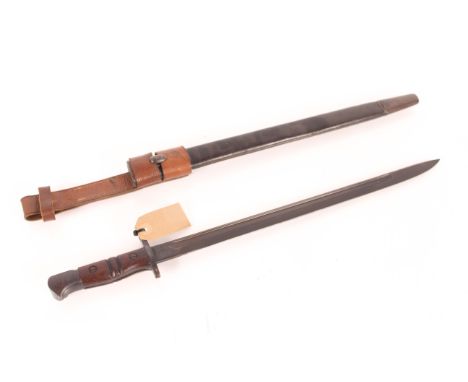 A fine model 1917 bayonet by Remington, complete with scabbard and leather frog, maker marked with broad arrow (Home Guard us