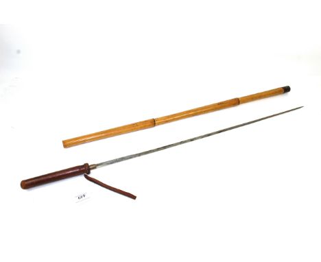 A sword stick with Toledo marked blade, leather covered grip, blade within cane shaft, an unusual variant 