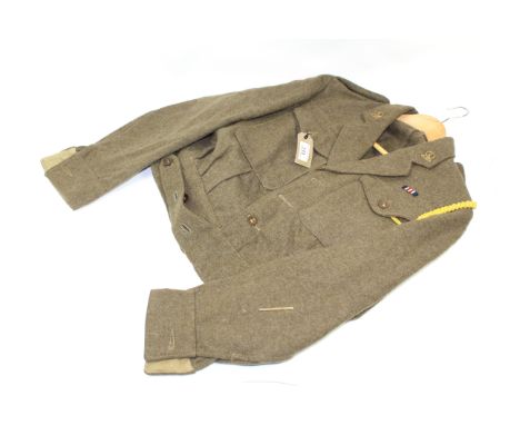 A WWII 1940 patt battle dress blouse dated 1945 complete with insignia for 14/20th Hussars and M.M. ribbon