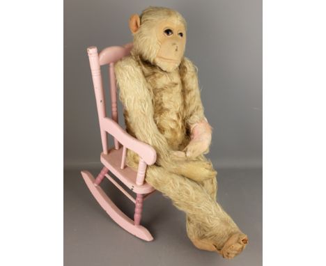 Large straw filled mohair Monkey with glass eyes, possibly  Steiff, H60cm with painted rocking chair (2)   Condition Report  
