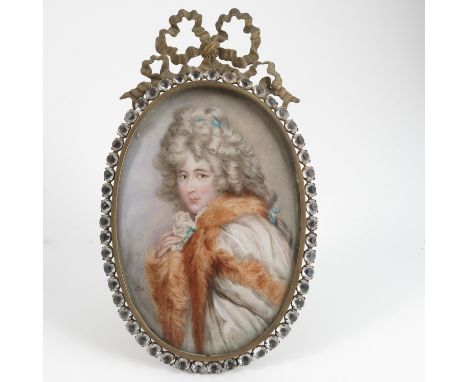 An oval portrait miniature, of a woman with ringlets and wearing a fur stole, monogrammed, in a gilt metal frame set with cle