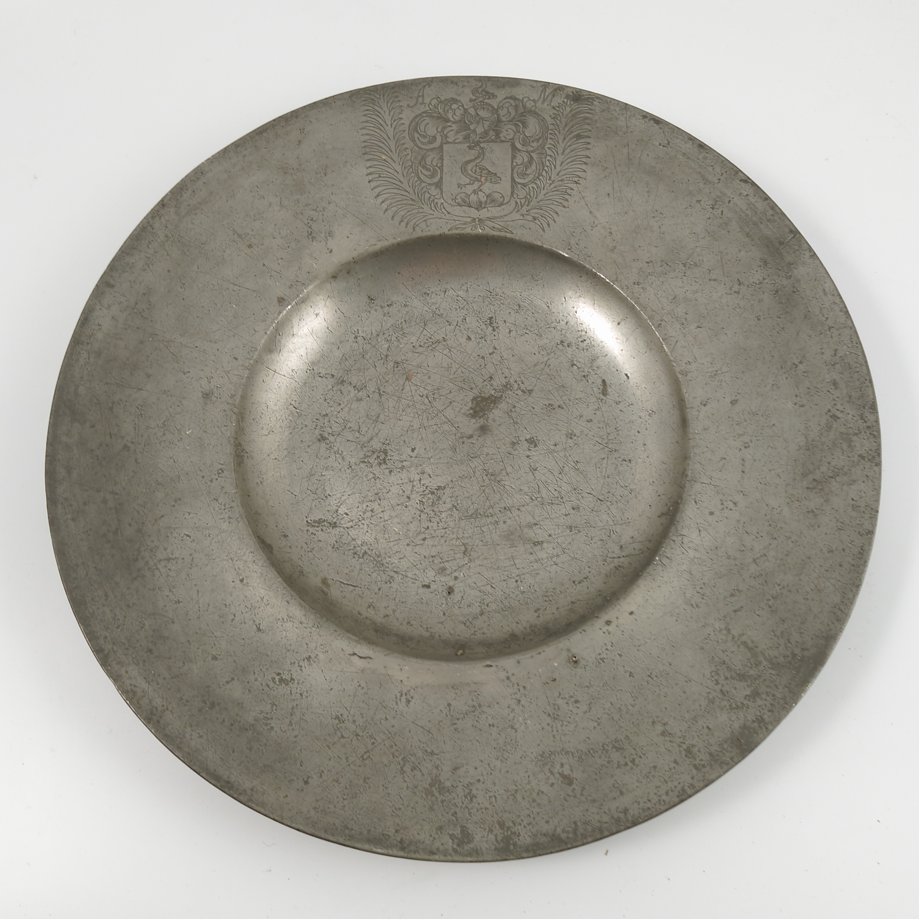 Five Antique pewter plates, all engraved or stamped with crests